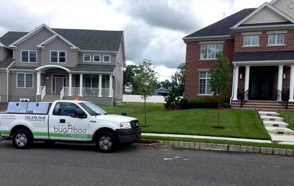 a bugaboo pest control company vehicle parked outside of two houses in New Jersey